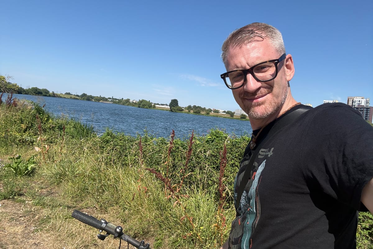 Dan out on his bike beside a reservoir